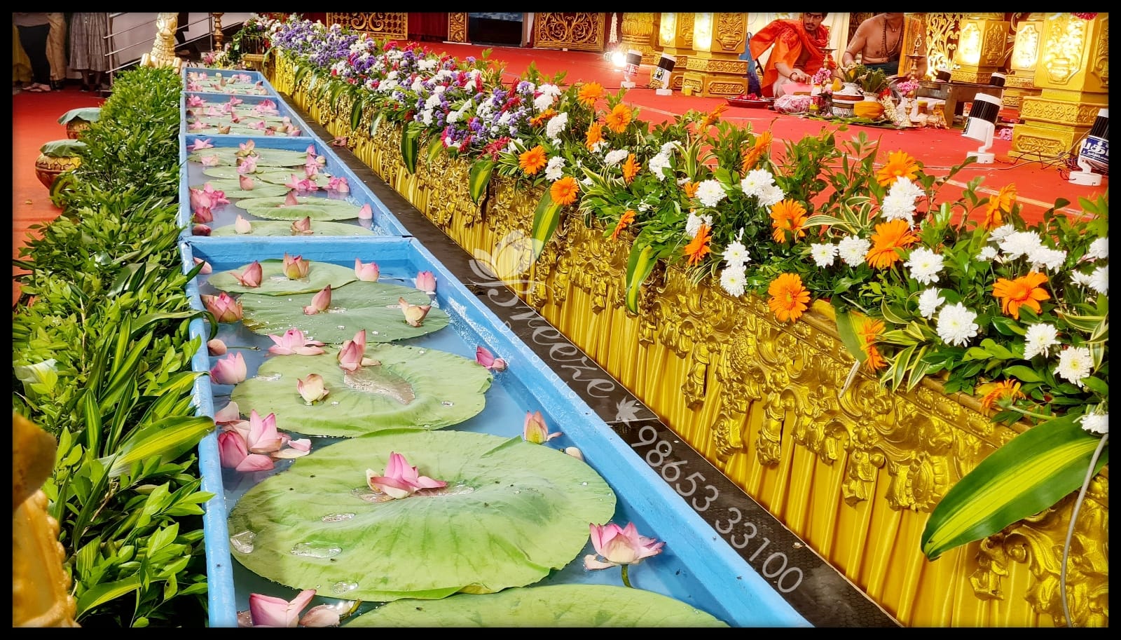 Floating pink lotus pond and fresh floral stage border in Coimbatore marriage event management by Breeze Decorators